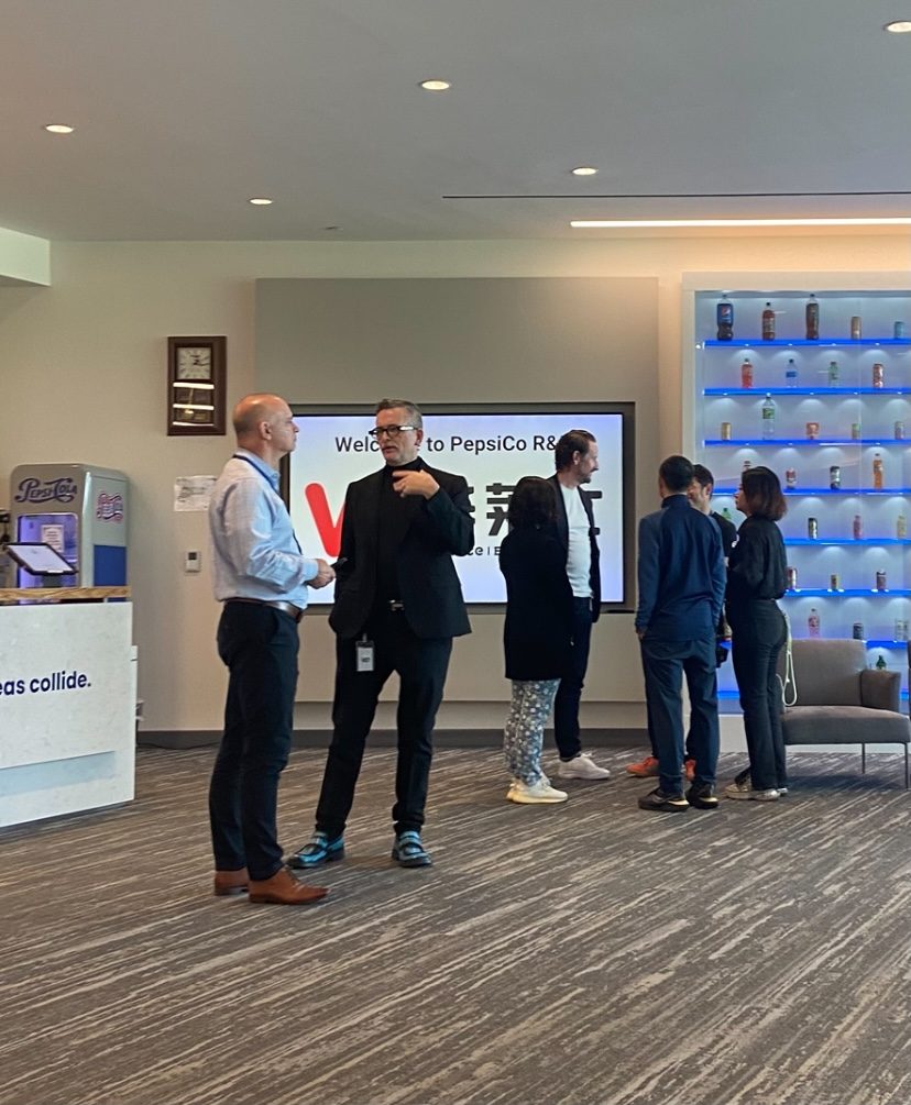 Guests talking during a visit to the PepsiCo design center