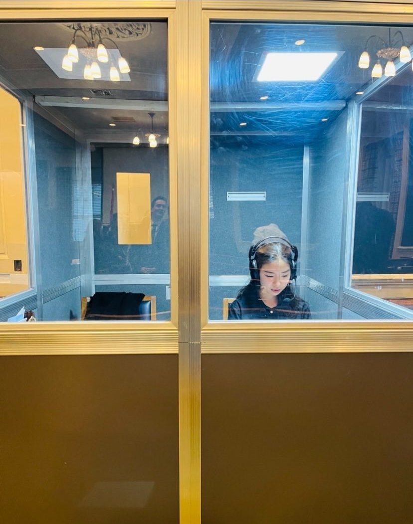 Cheng Shen working inside a glass interpreter booth